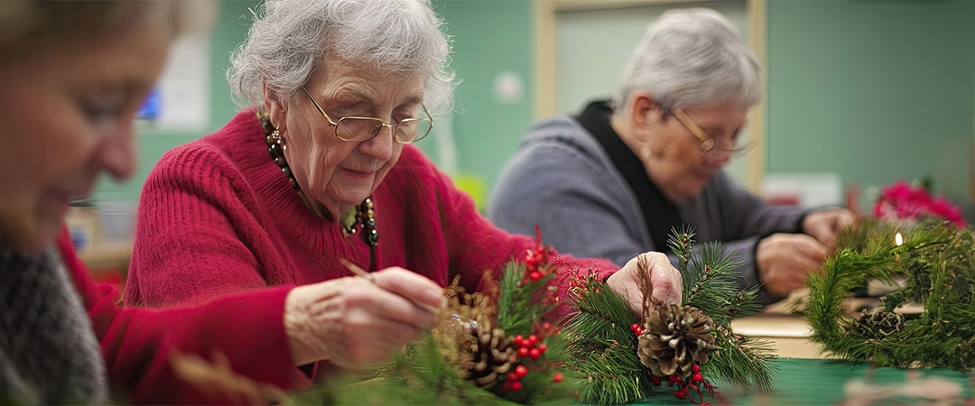 Seniors doing holiday crafts together.